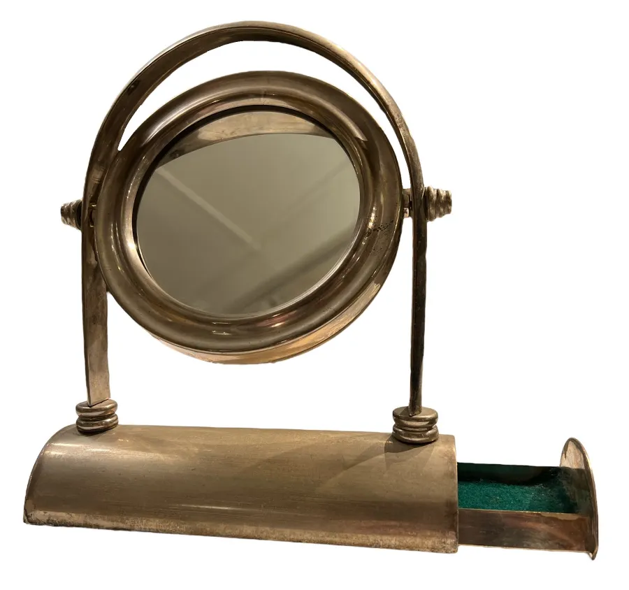Antique Art Nouveau mirror with decorative base and compartment.