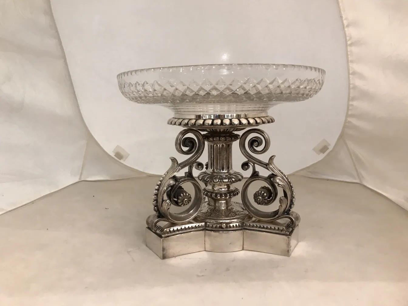 antique centerpiece Christofle with decorative base and clear surface, in a neutral setting