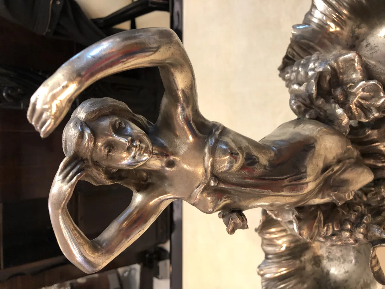 decorative antique centerpiece with sculpted figure and flowers