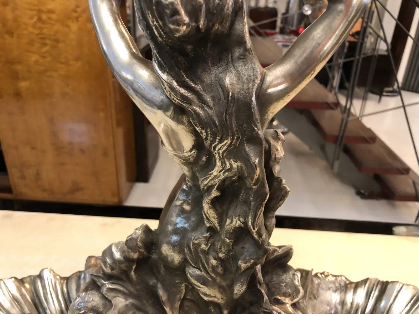 antique centerpiece featuring a female figure and decorative details