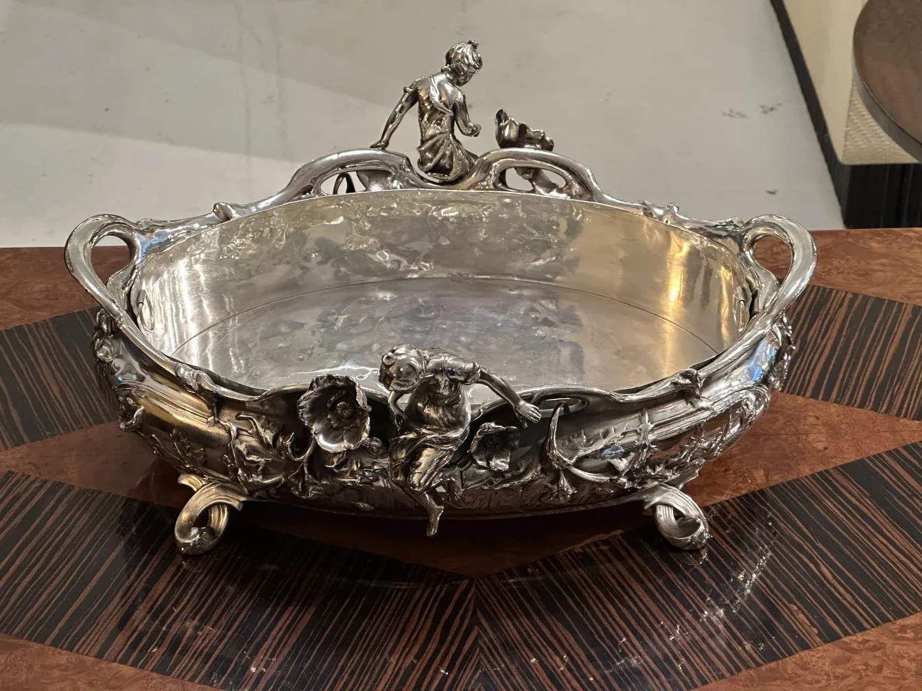 antique centerpiece with decorative figures and flowers