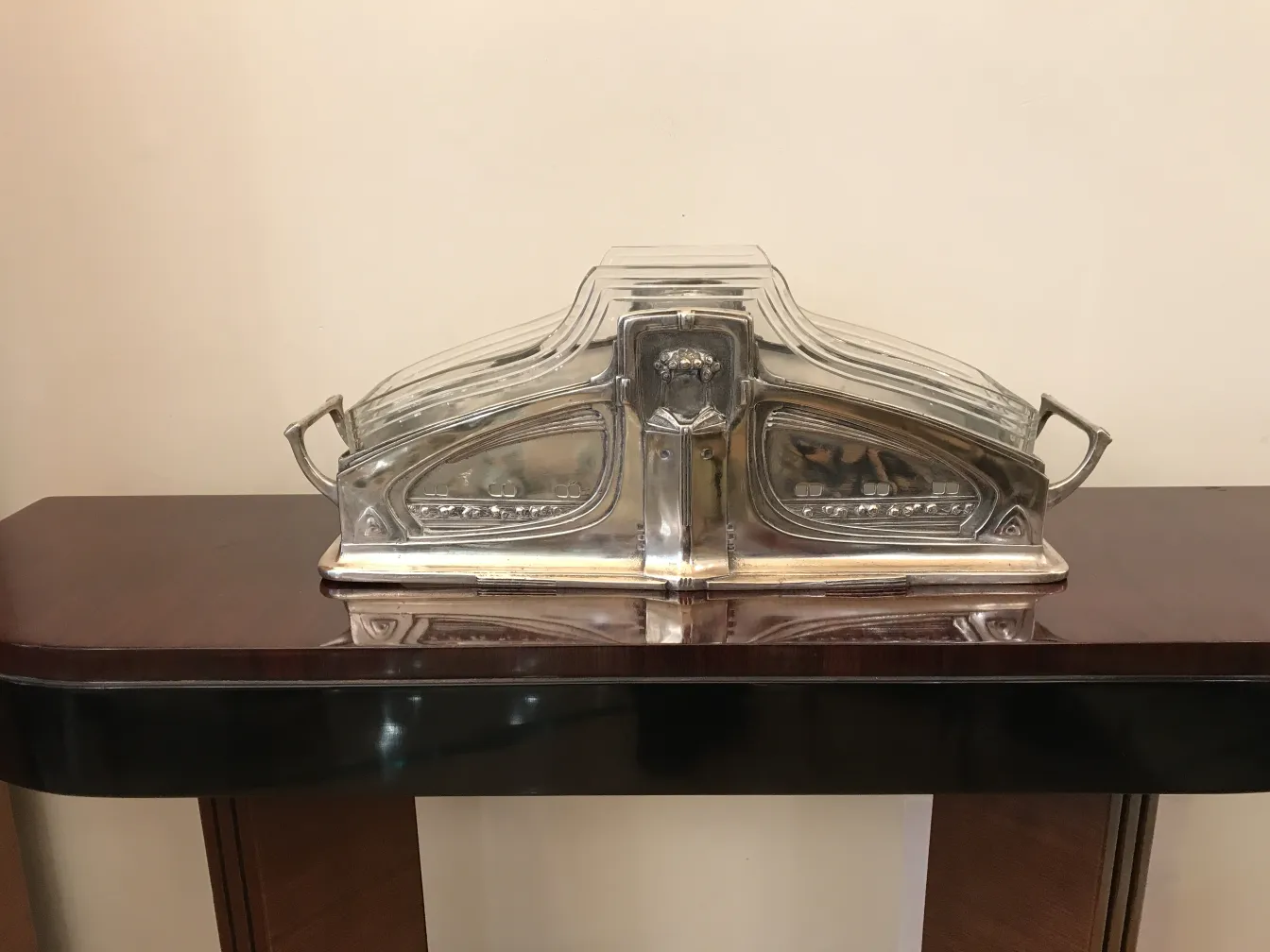 WMF centerpiece with elegant design, placed on a shiny wooden table.