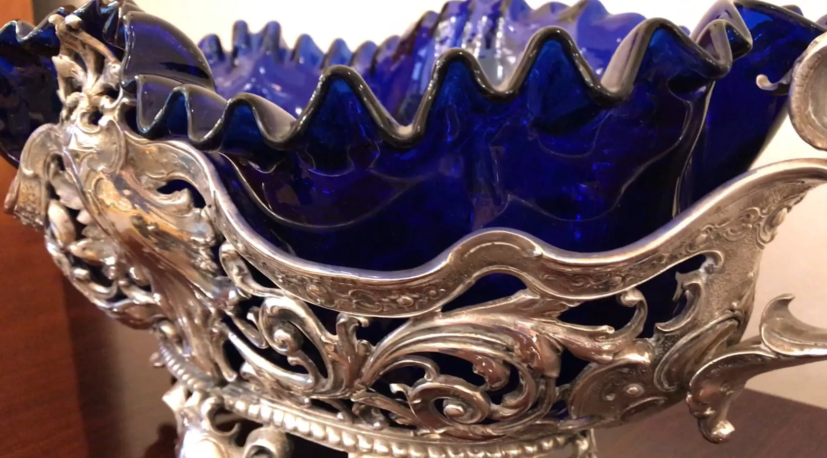 wmfn centerpiece in blue with elegant ruffled edges on a wooden table