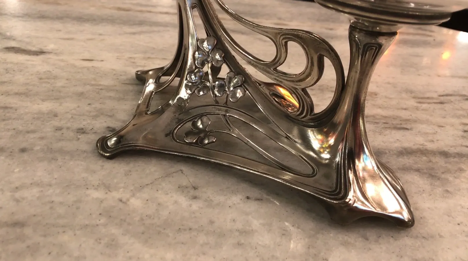 Elegant base of antique centerpiece WMF with floral adornments, sophisticated setting