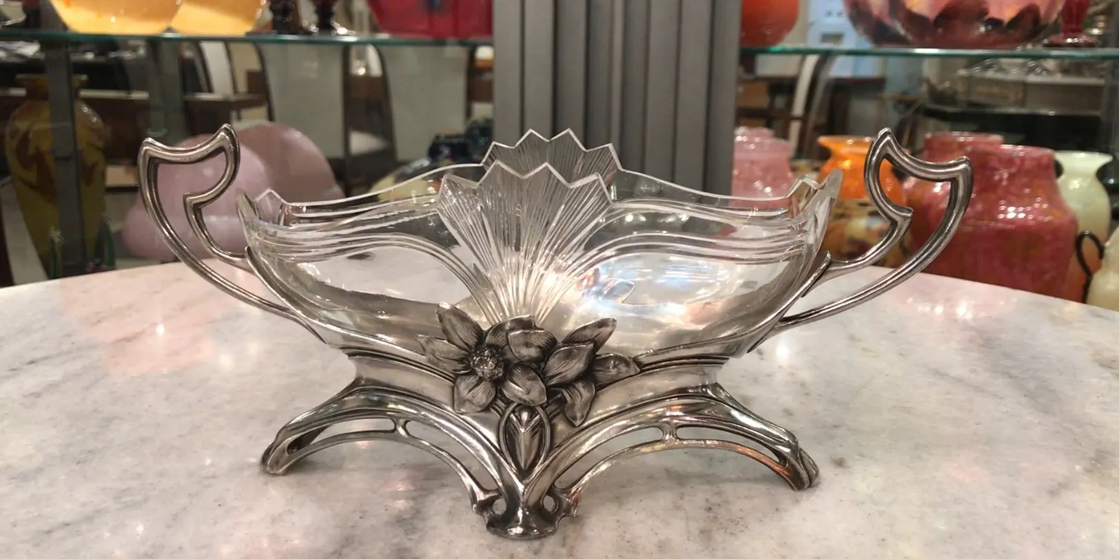 antique WMF centerpiece with floral design, cozy antique setting.