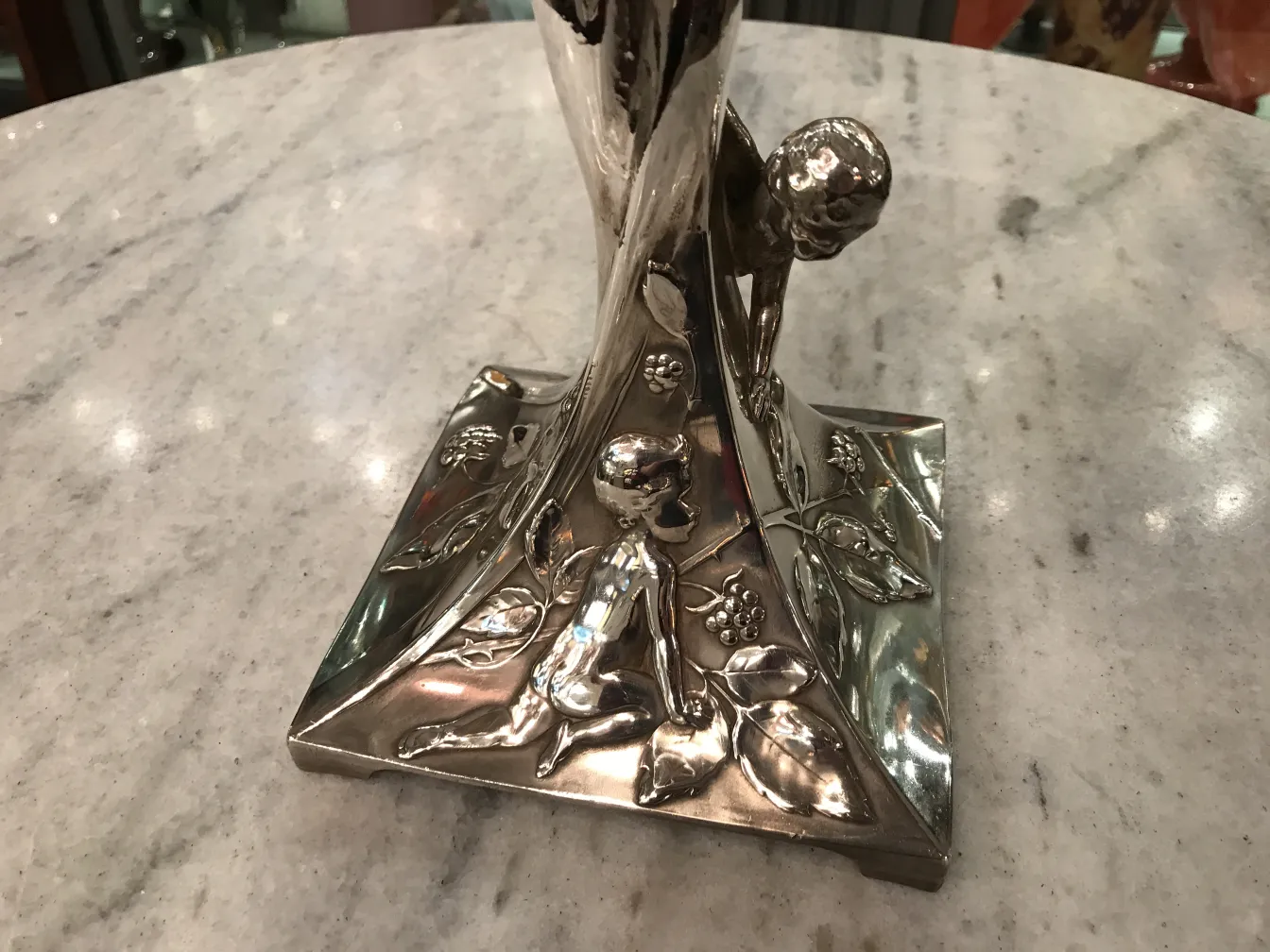 antique WMF centerpiece with floral details on the base