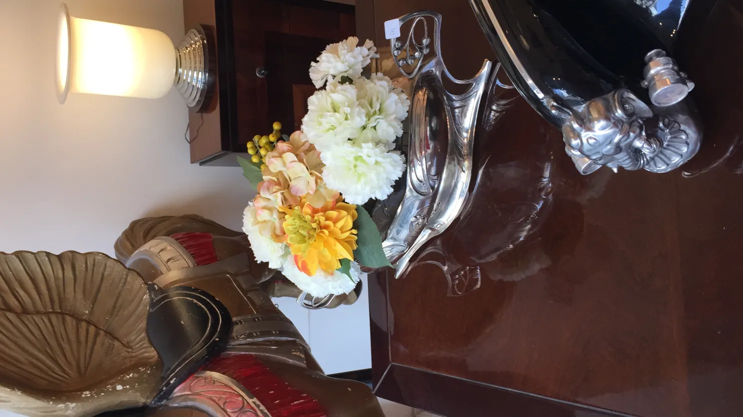 wmf centerpiece with white and colorful flowers on a cozy table