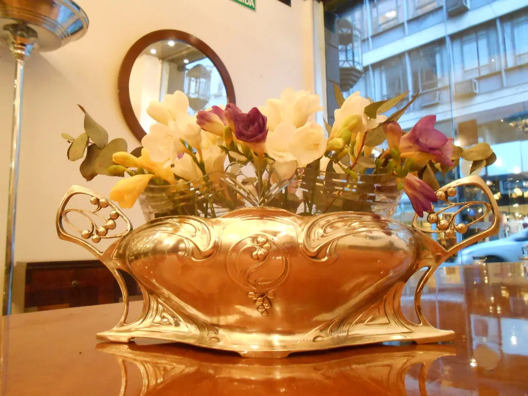 antique centerpiece wmf adorned with flowers in an elegant environment