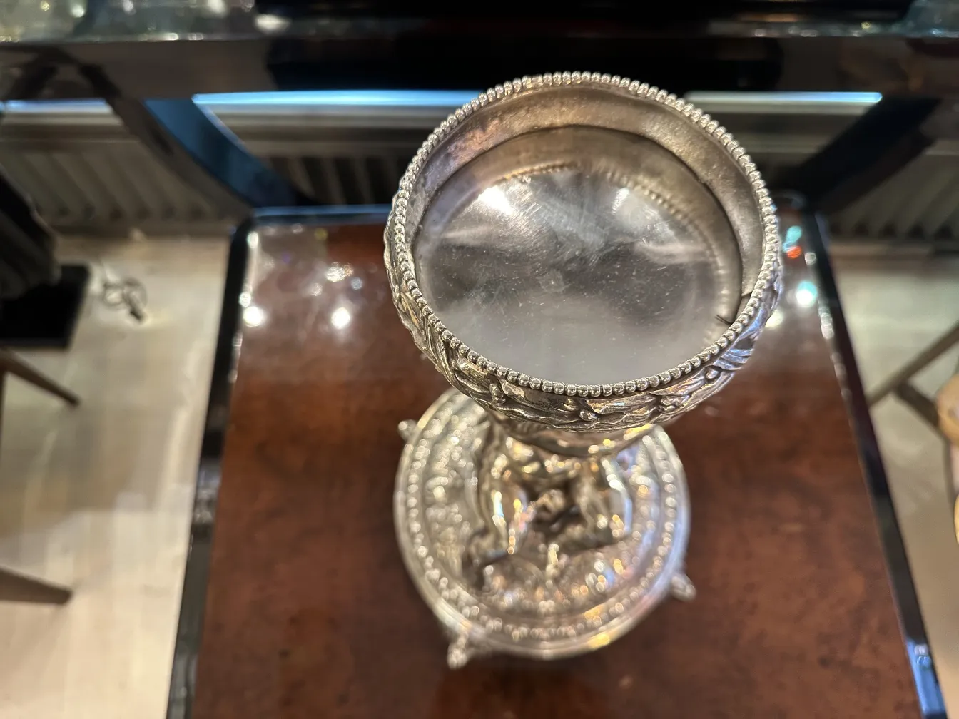 Antique WMF centerpiece with ornate details in an elegant setting.