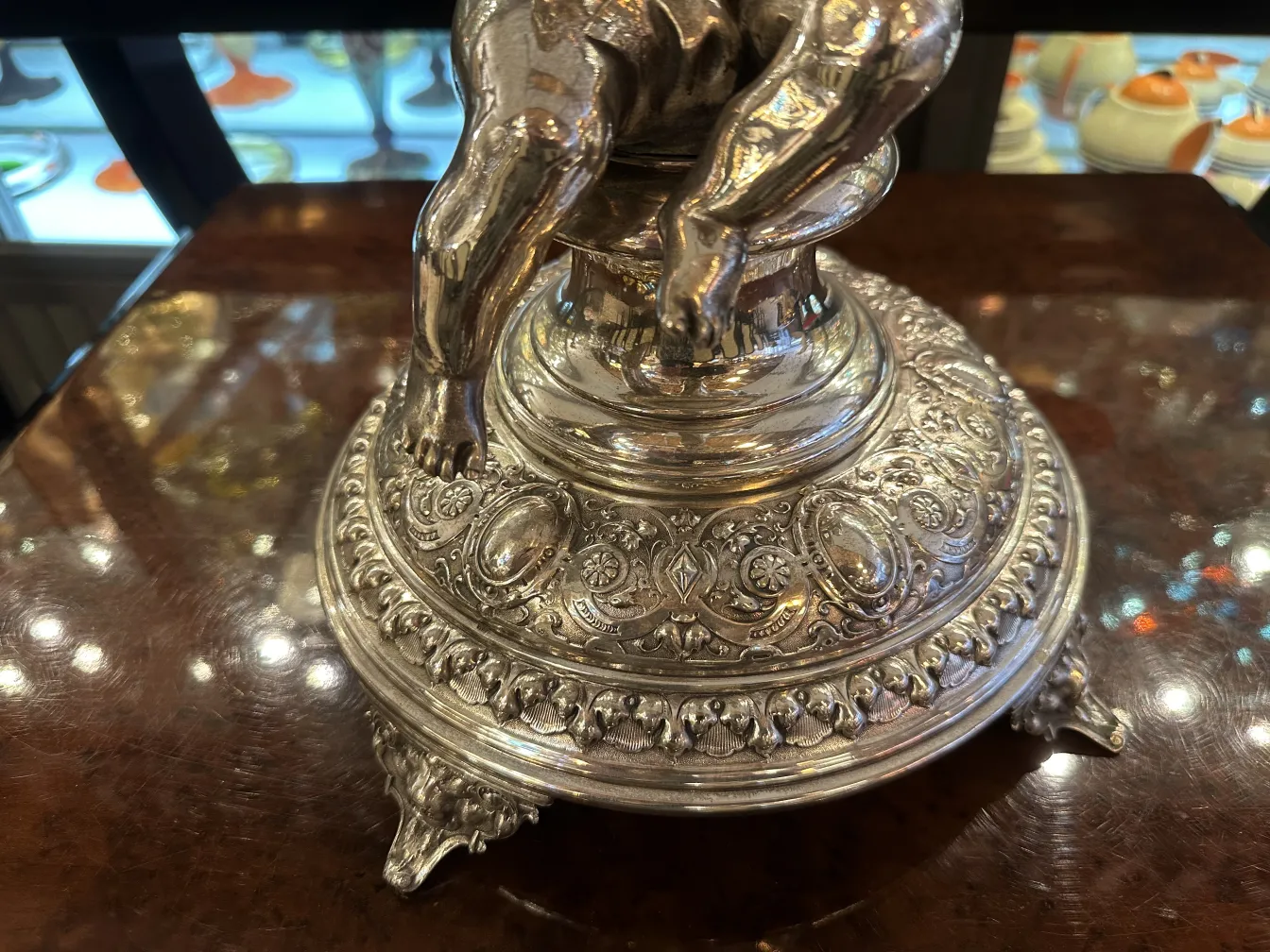 antique wmfd centerpiece with intricate design and ornamental details, on a wooden table