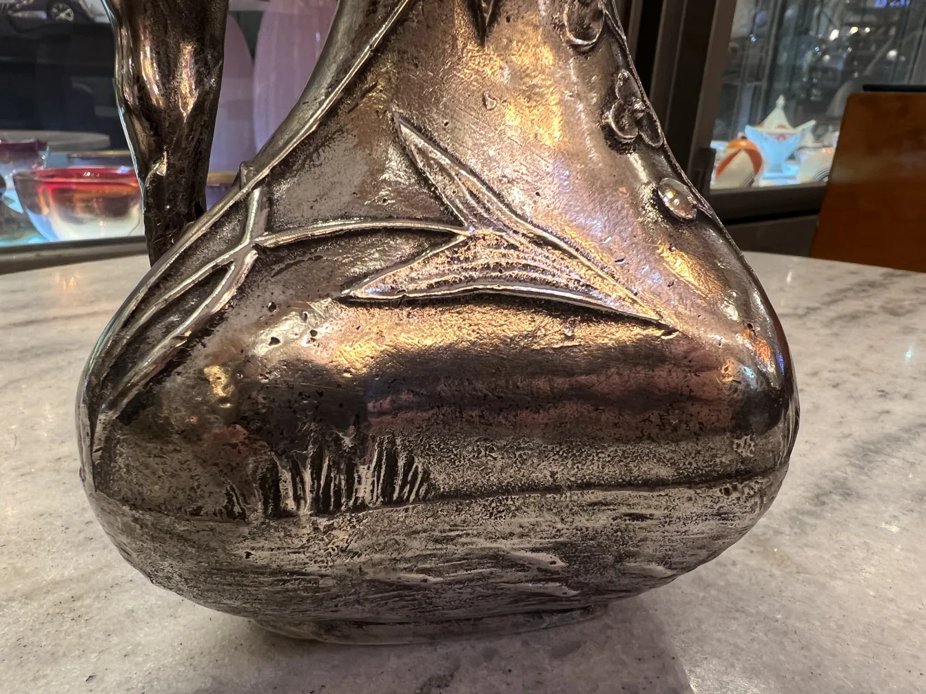 antique jar featuring a floral relief design and details