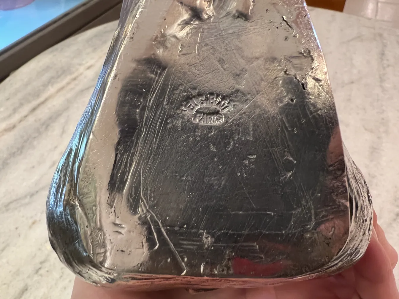 Antique jar with polished surface and visible marks, classic design.