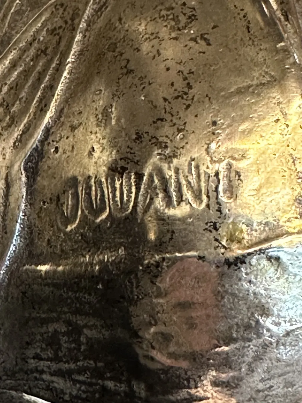 antique jar with intricate designs in a rustic setting