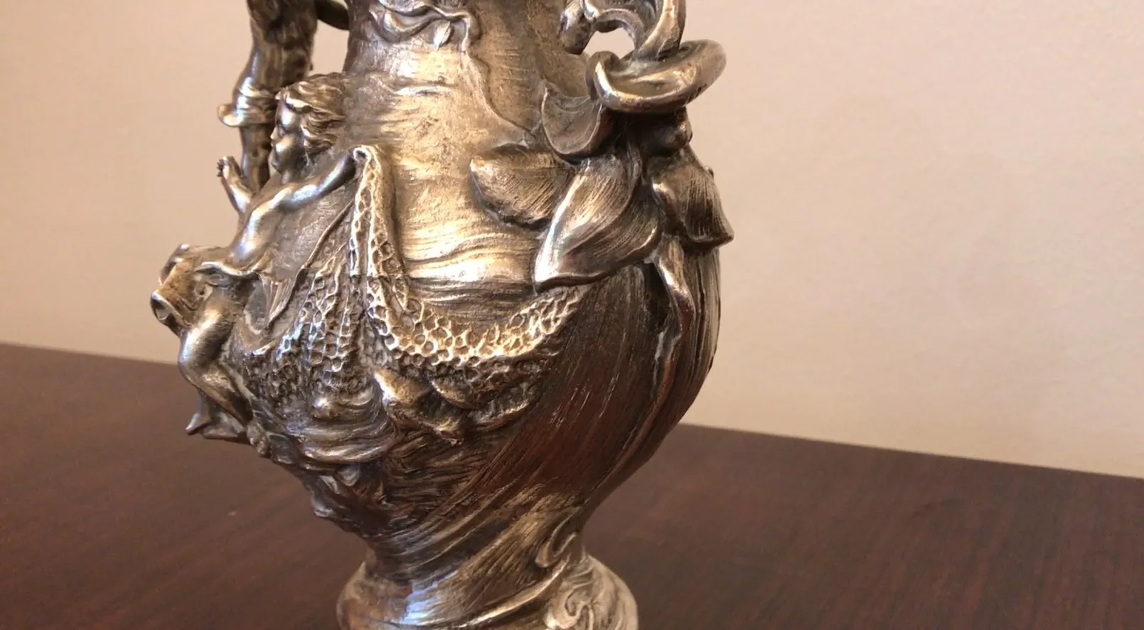 antique jar featuring decorative reliefs and flowers