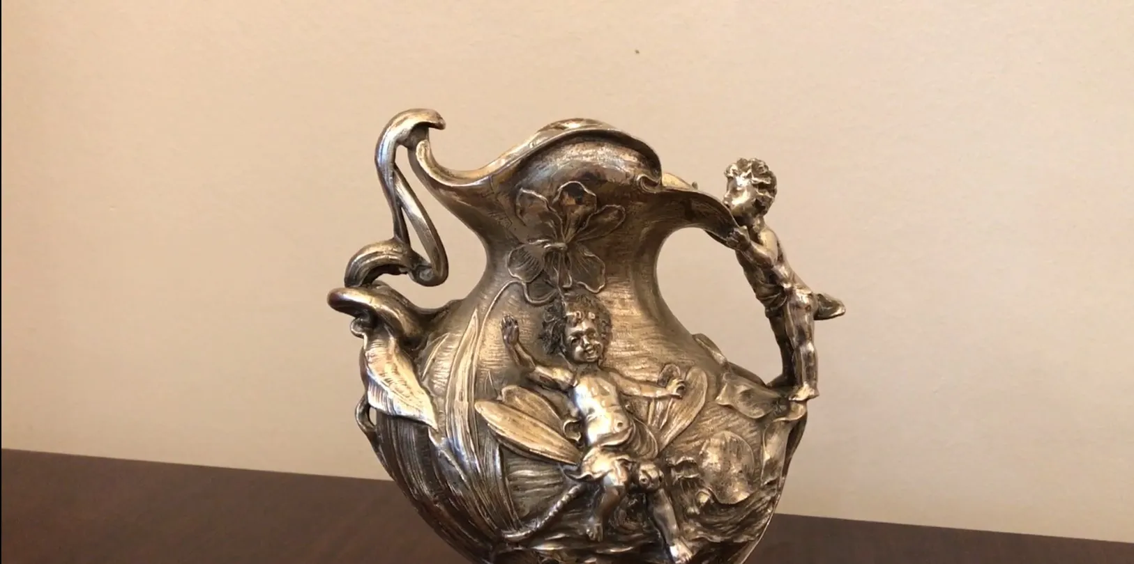 antique artistic jar featuring a child and a flower