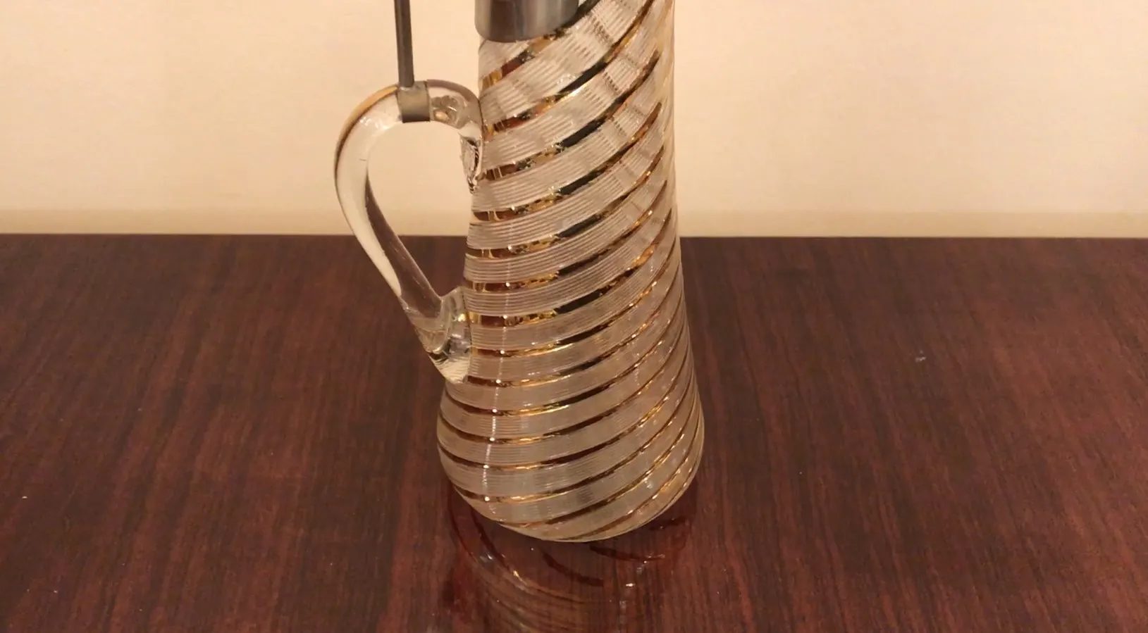 2 antique WMF jars, featuring spiral design, placed on wooden table