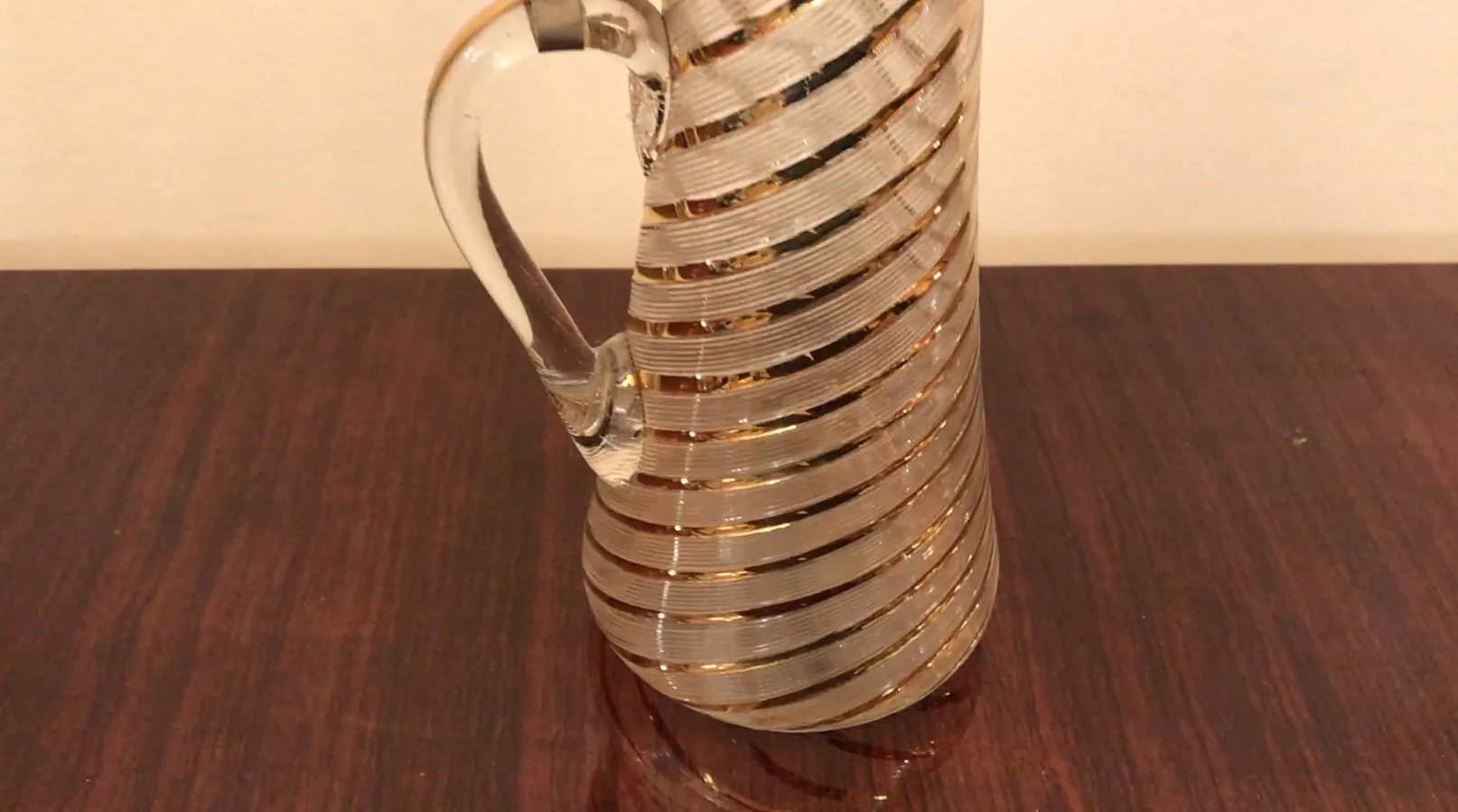 Side view of 2 vintage jars wmf with spiral design and gold details.