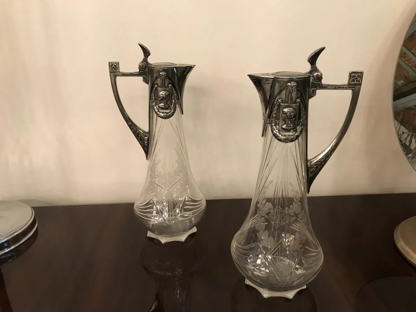 Deux pichets WMF anciens avec des designs élégants et des décorations.