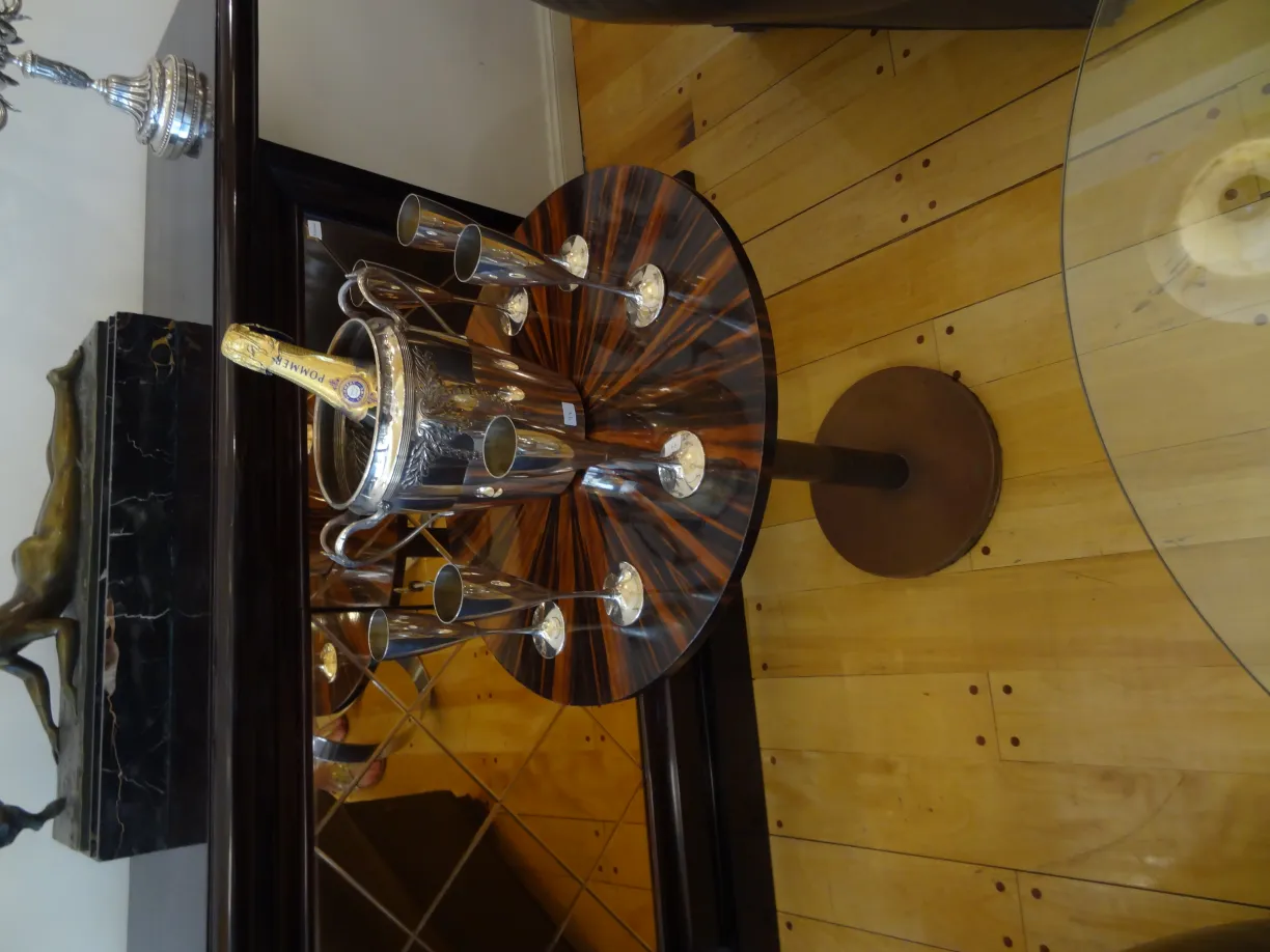 antique WMF champagne cooler with glasses arranged around on the table