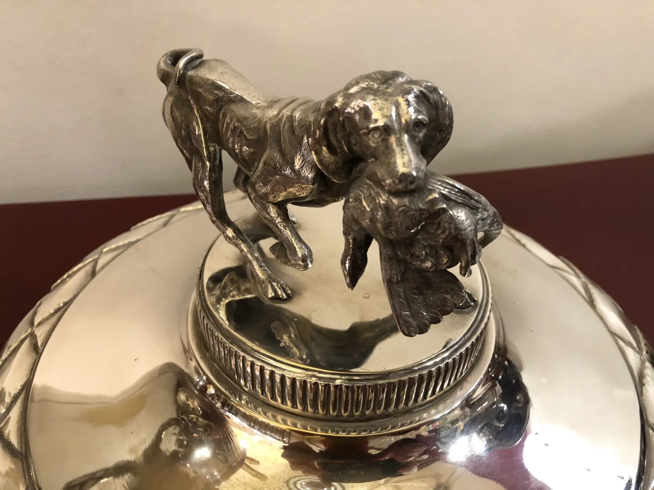antique with dog figure holding fish on champagne cooler