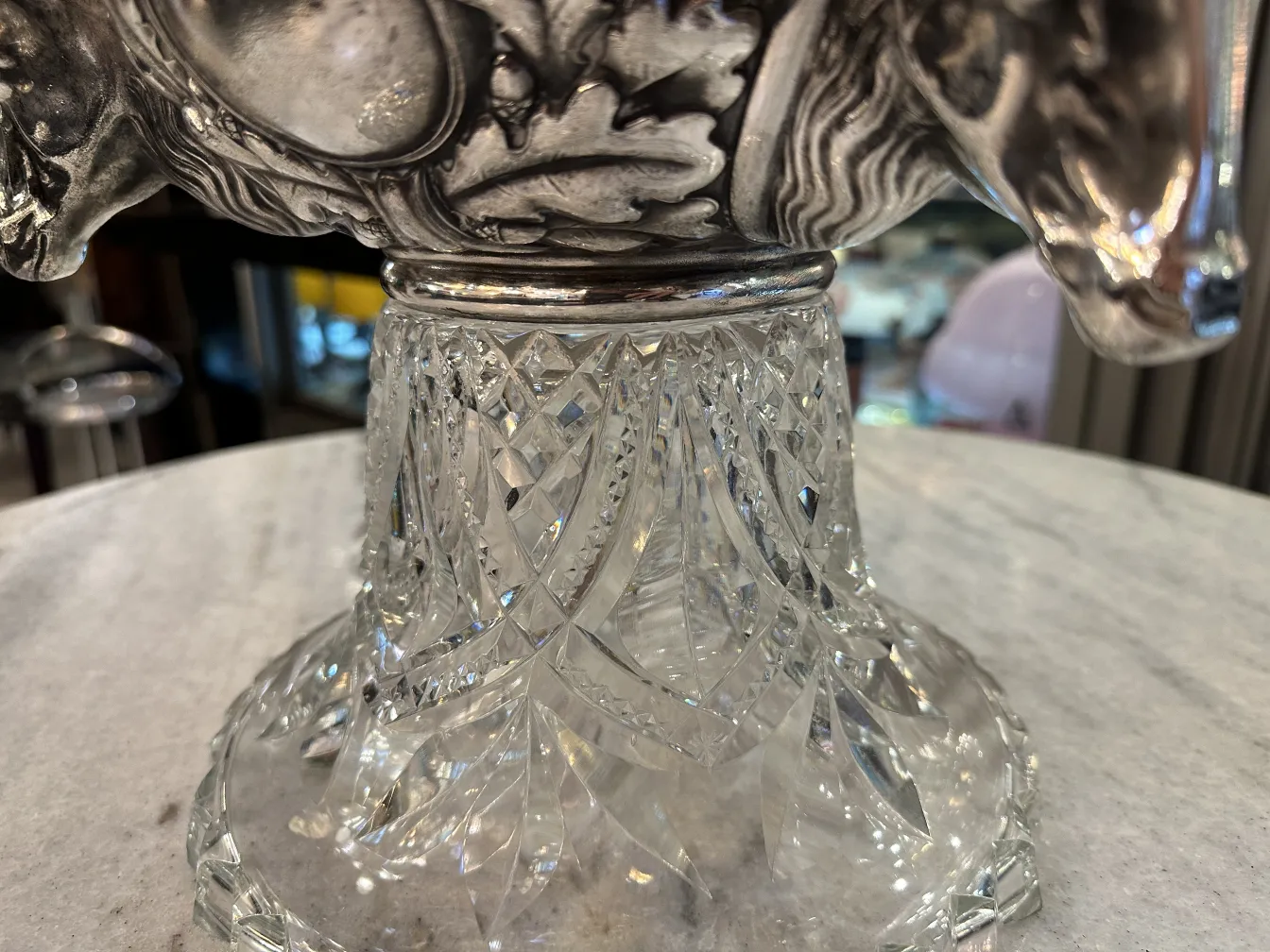 View of an antique punch bowl wmfi with a crystal base, details on the top.