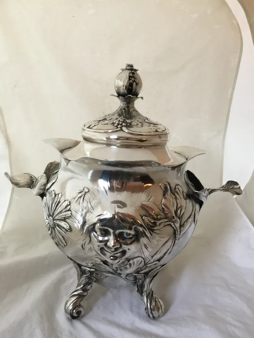antique WMF punch bowl with intricate design and feet