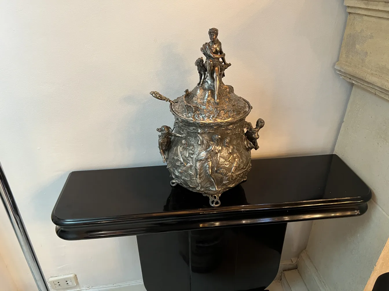 Antique WMF punch bowl adorned with reliefs, set in an elegant ambiance