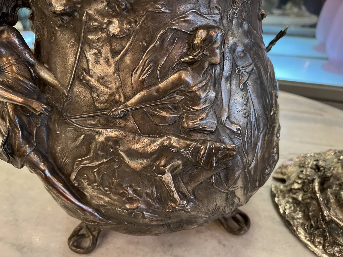 Antique WMF punch bowl with sculptural details on its surface and classical style.