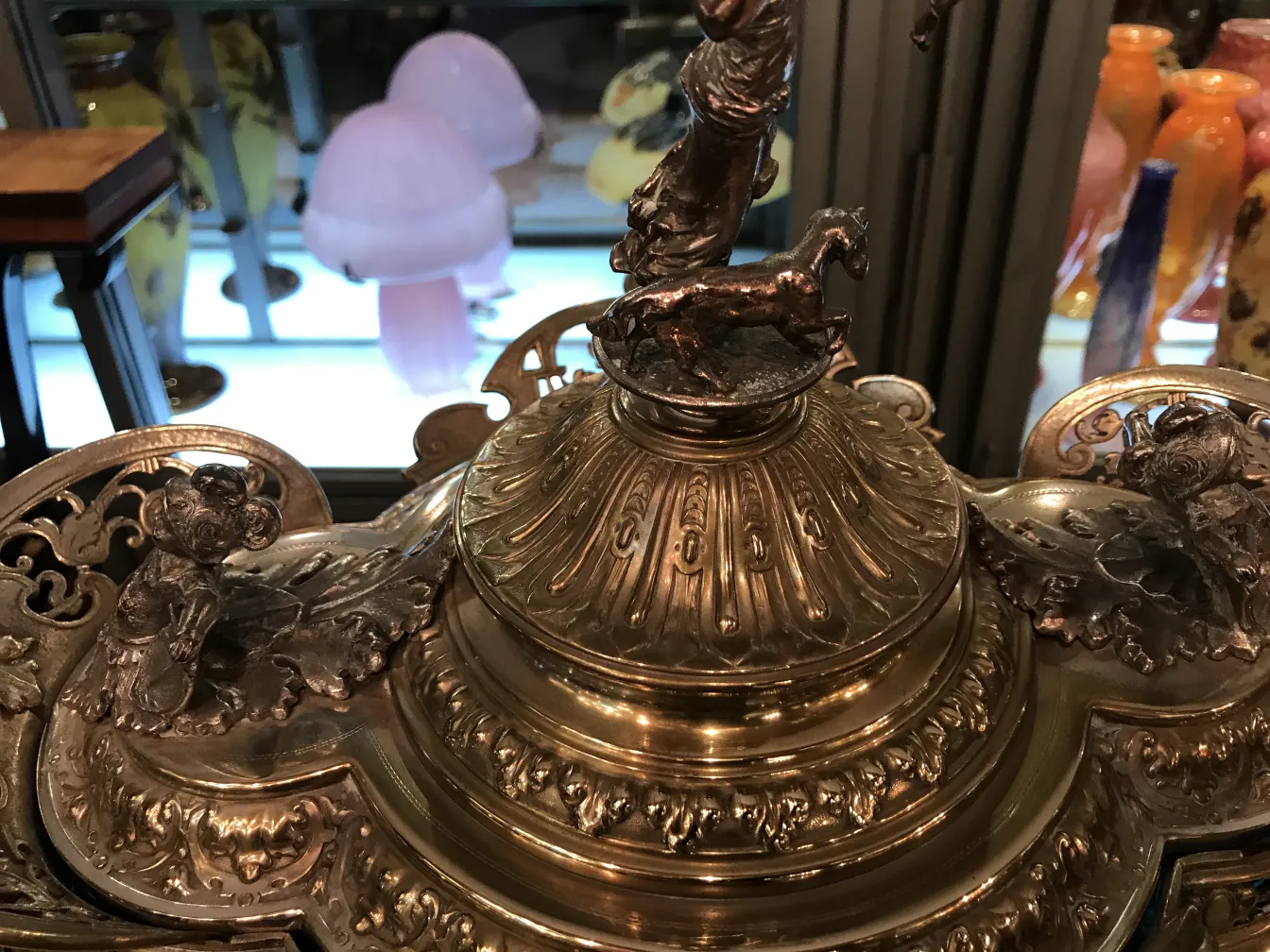 Antique WMF punch bowl with decorative features and a horse on top.