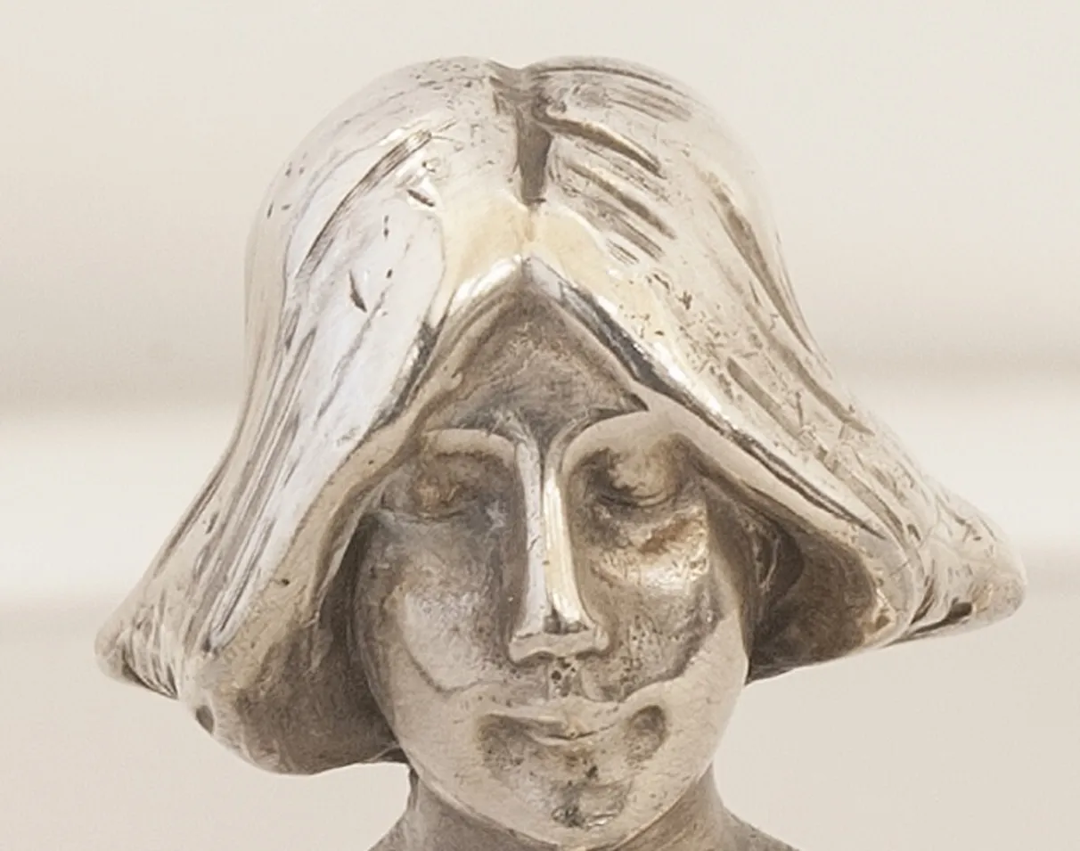 antique WMF card tray featuring a decorative figure on top