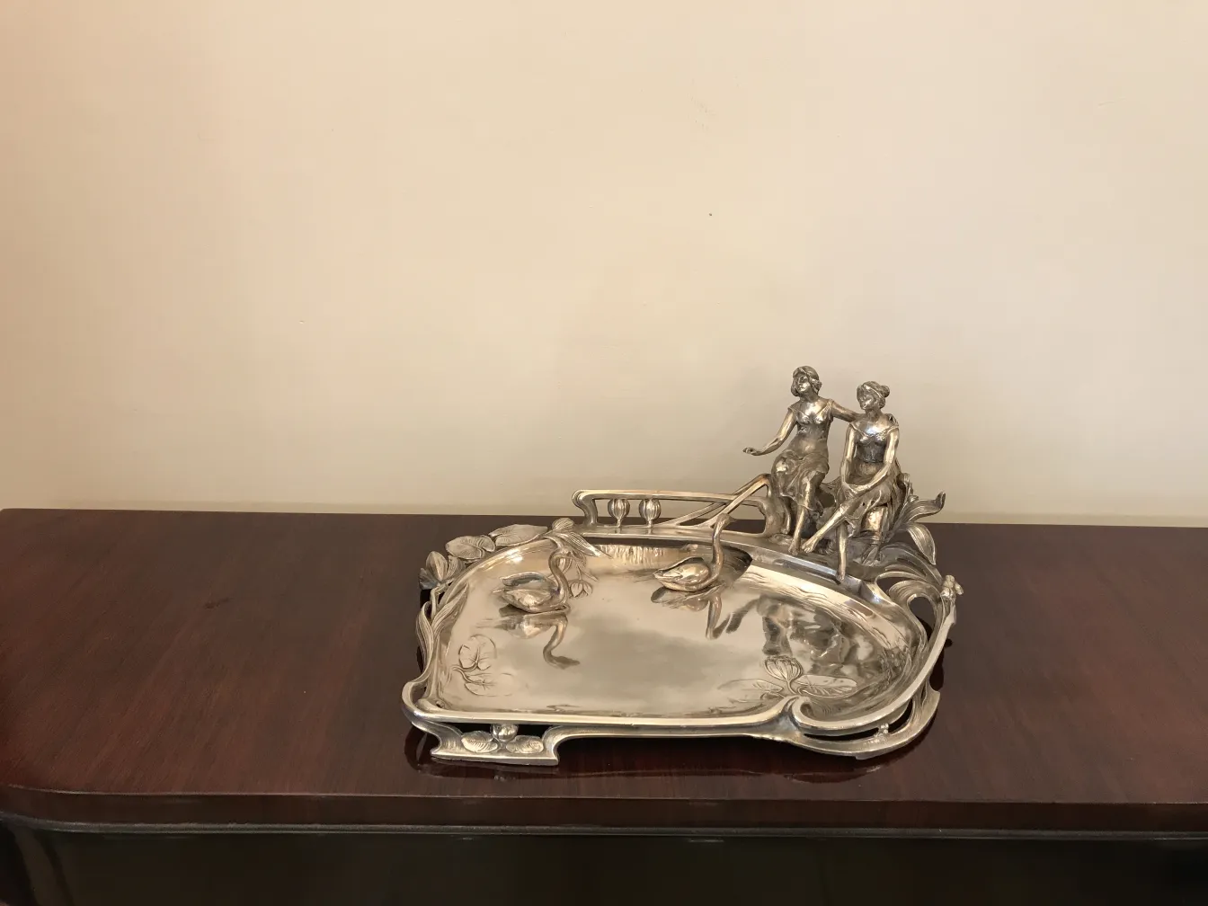 antique card tray featuring decorative figures and elegant shapes