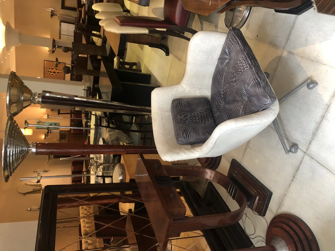 Antique armchair in a setting with other furniture pieces.