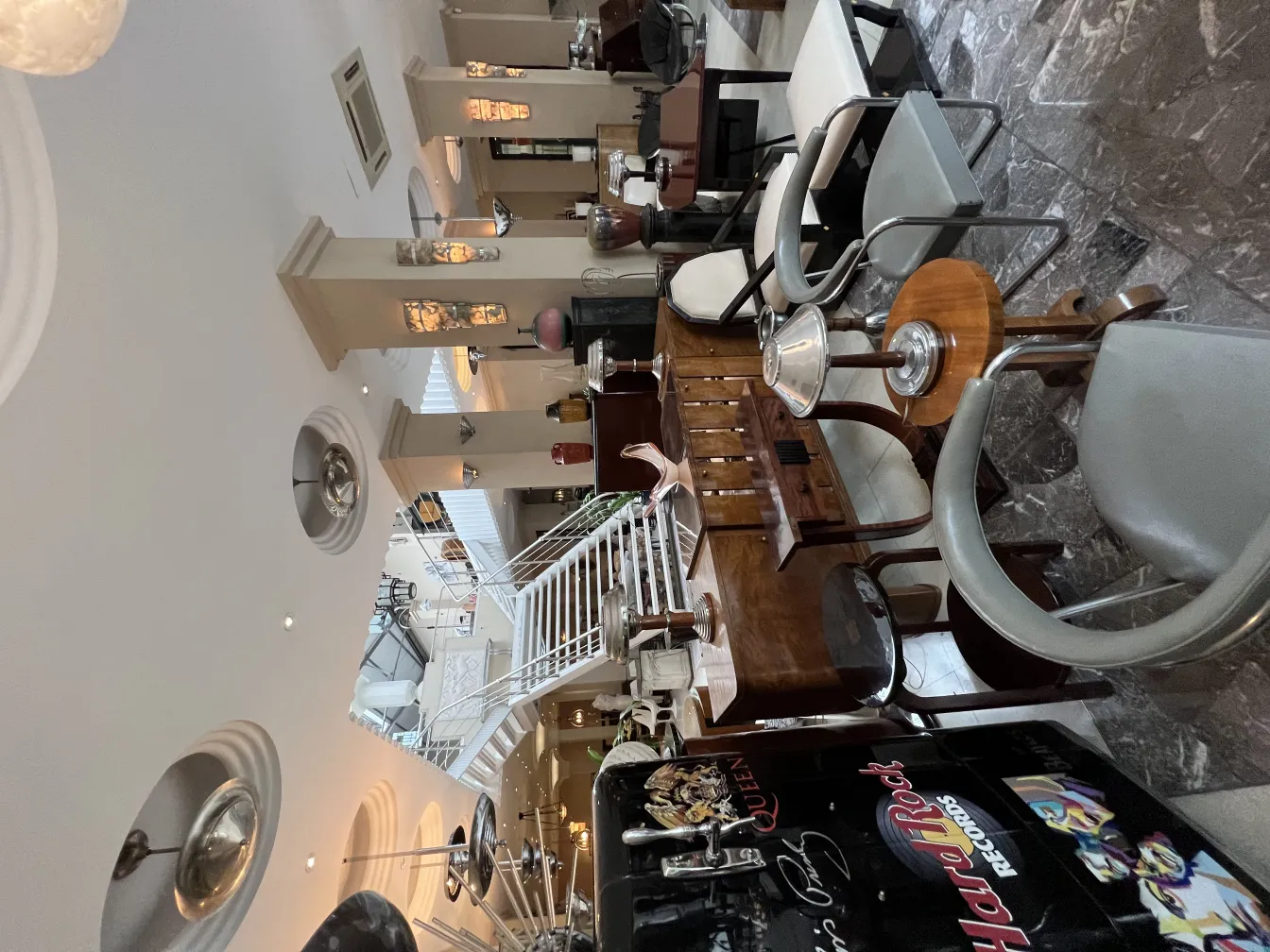 An antique comfortable armchair in an elegant setting with dim lights and wooden tables.