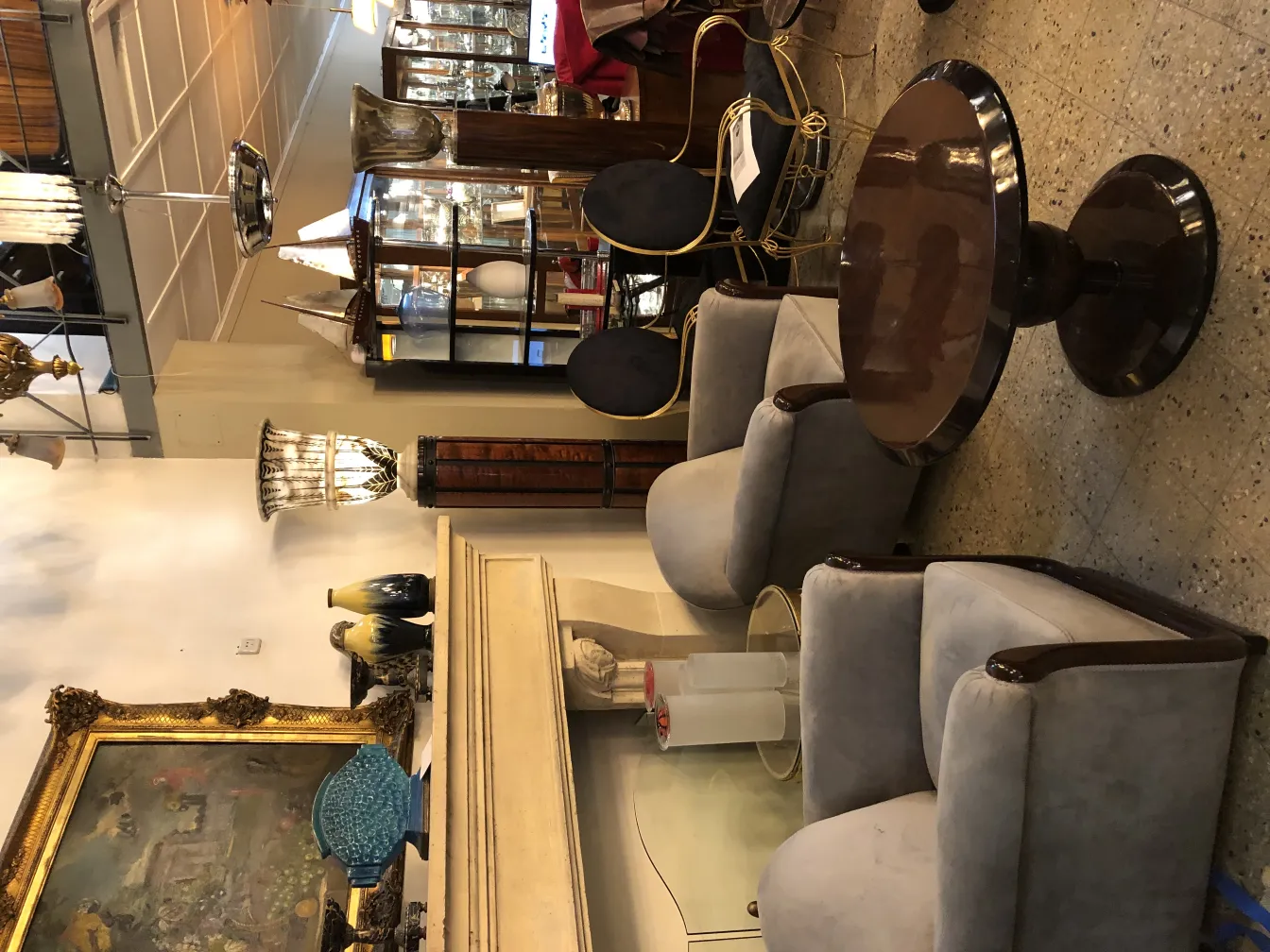 Front view of 2 antique armchairs in a cozy setting