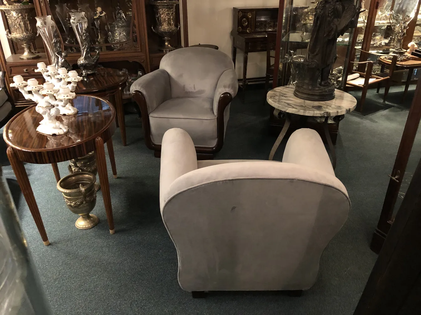 Two antique armchairs in a stylish setting.