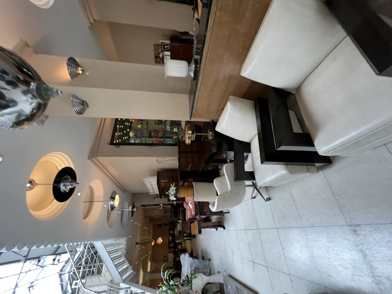 View of 2 antique armchairs in an elegant setting with decor.