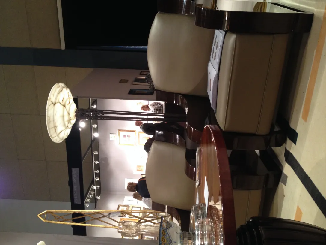 view of 2 antique armchairs in a softly lit environment