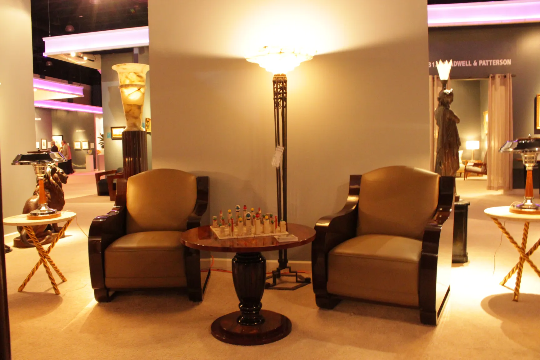 two antique armchairs in a cozy environment with a table and lamp