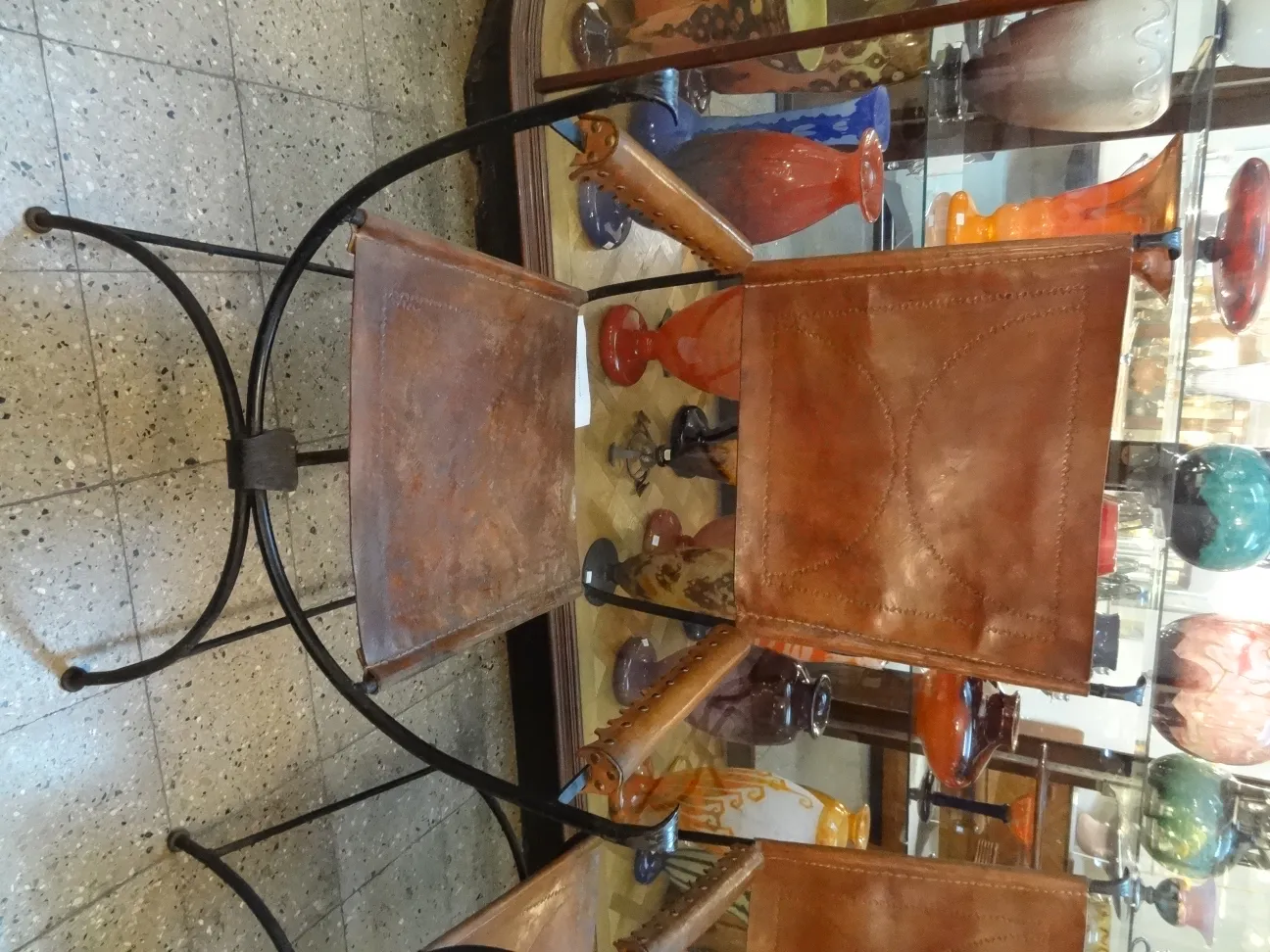 A pair of antique armchairs in a decorative setting with vases