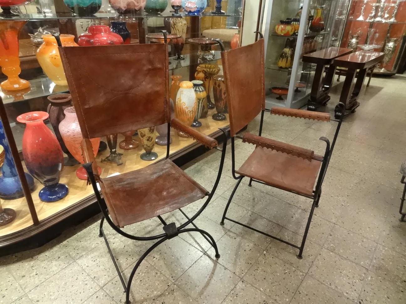 two antique armchairs with an attractive finish in an antique shop setting