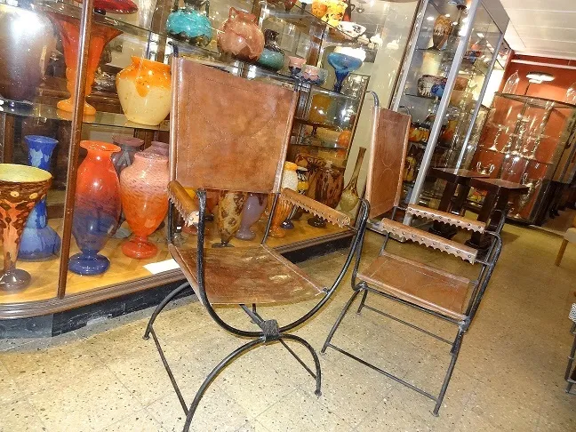 Two antique armchairs in a cozy setting with colorful decorations.