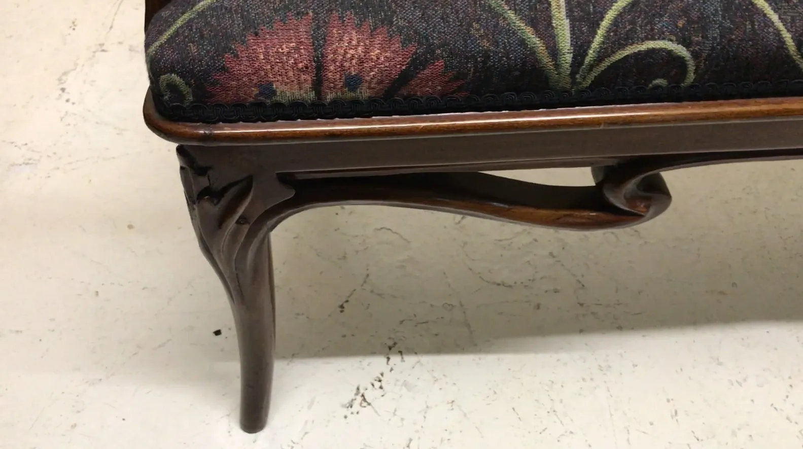 Set of three antique armchairs with elegant design in a cozy setting.