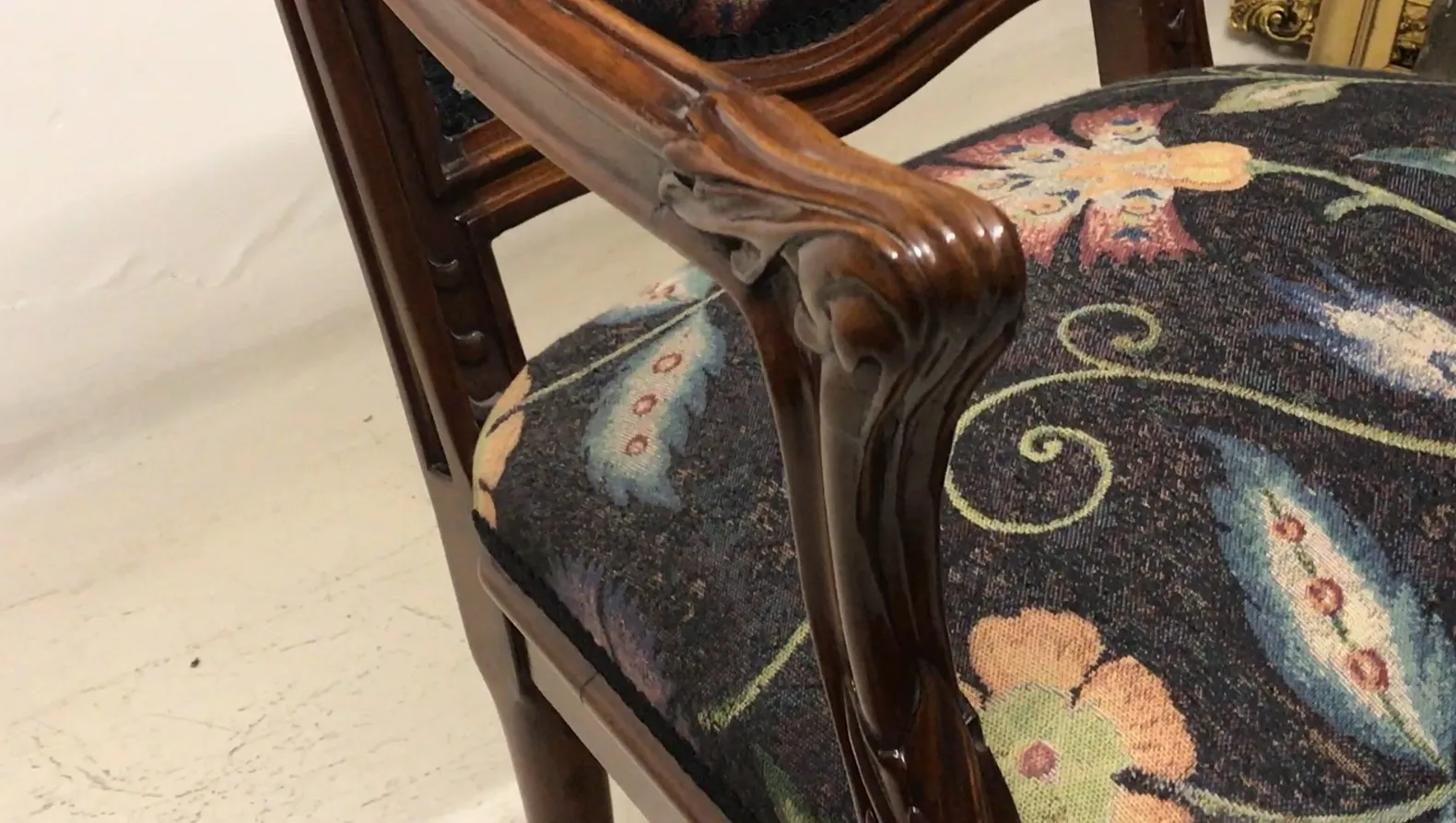 3 antique armchairs with floral upholstery in the setting