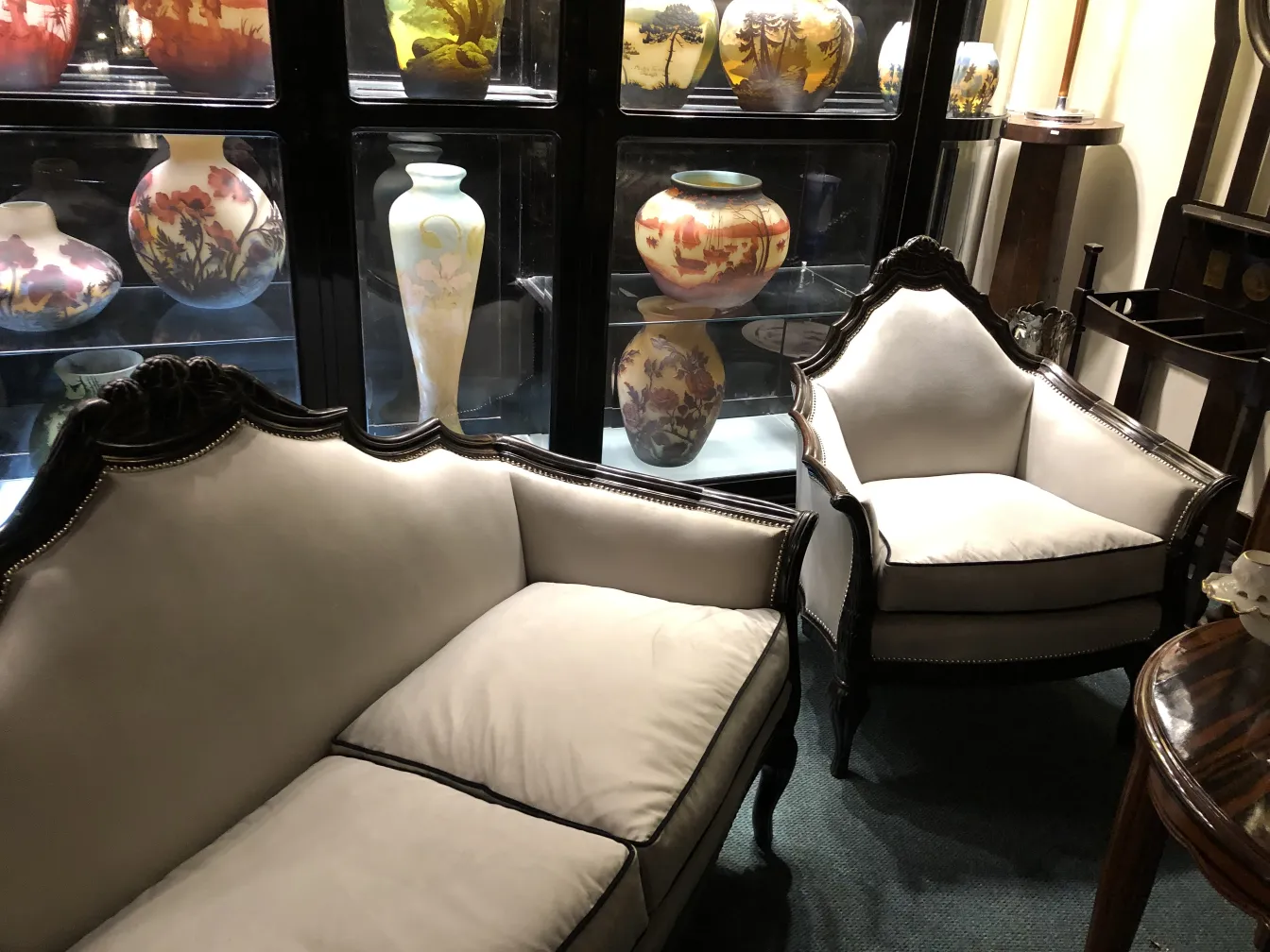 Three antique armchairs, elegantly designed, in a setting with decorative vases