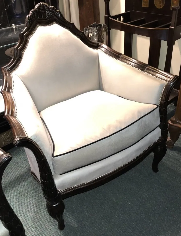 Three antique armchairs with decorative details and elegant shape in a cozy environment