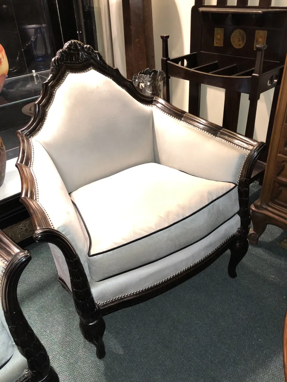 Three antique armchairs with elegant arms and decorative details