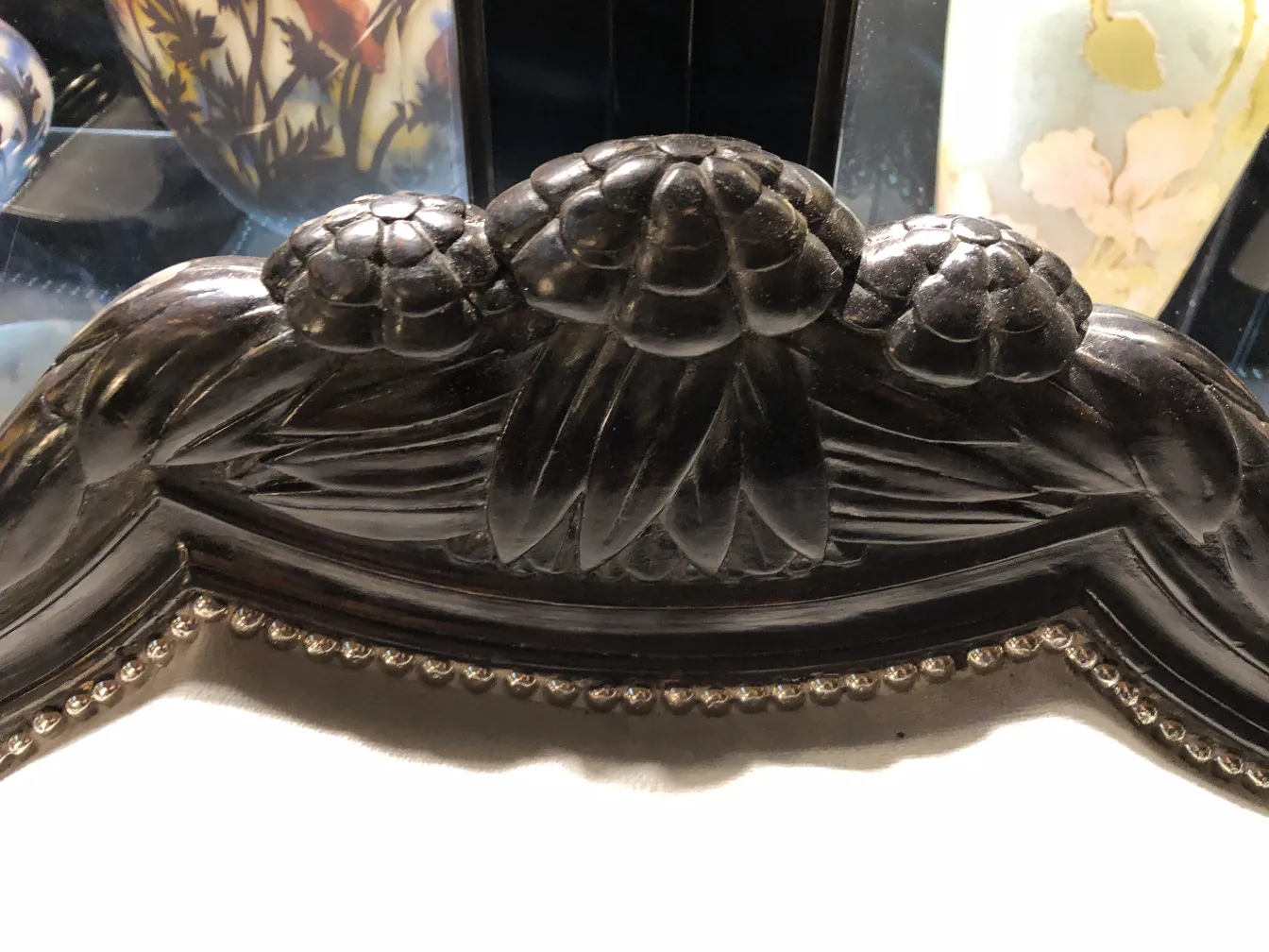 Trois fauteuils anciens avec des motifs floraux détaillés dans un cadre classique.