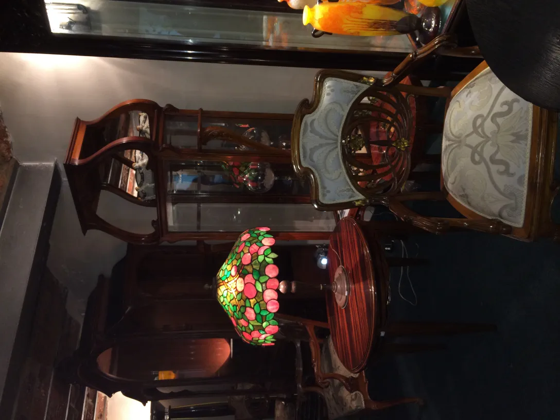 5 antique armchairs in a cozy setting with a colorful lamp