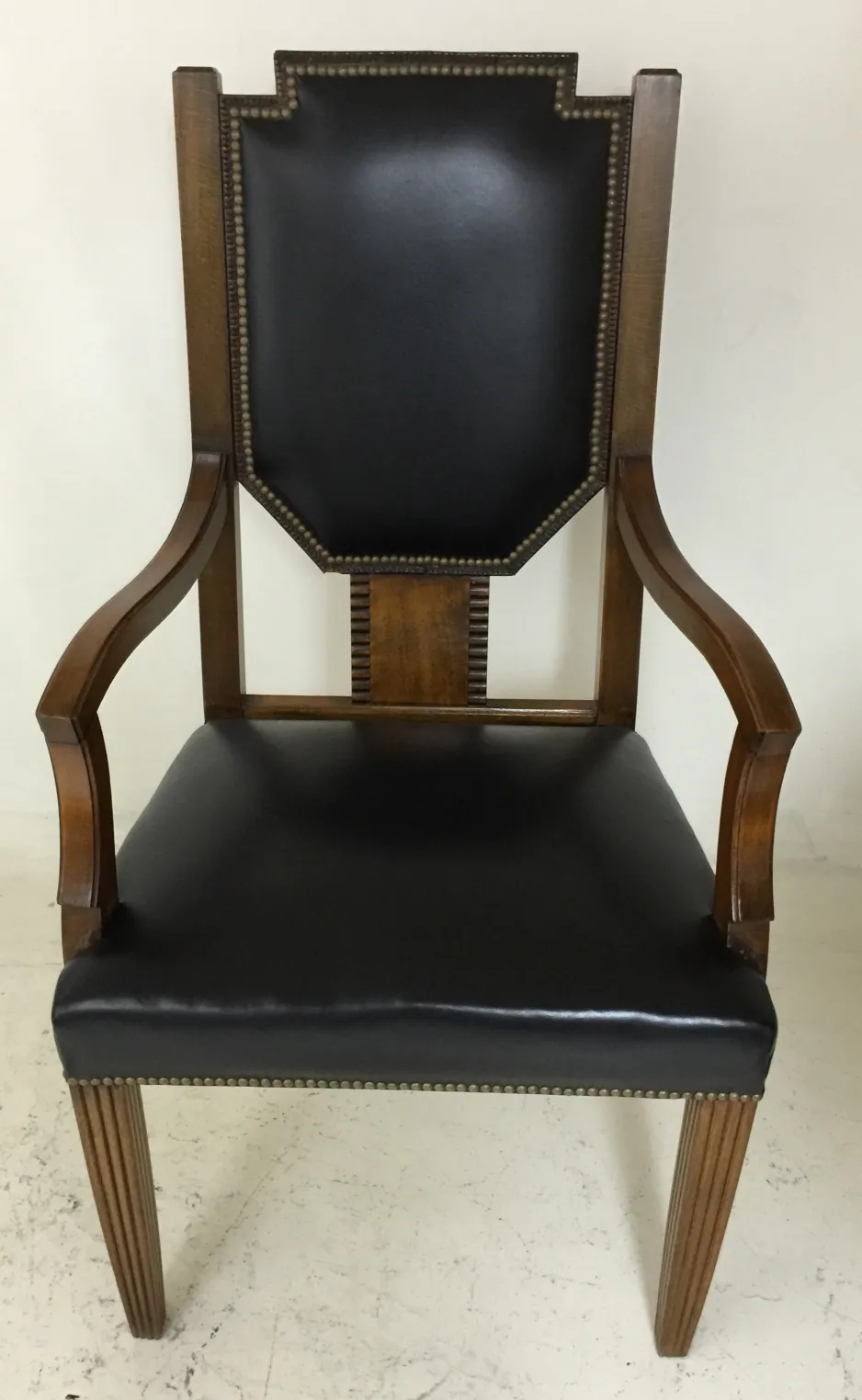 Antique desk chair with black backrest and straight legs