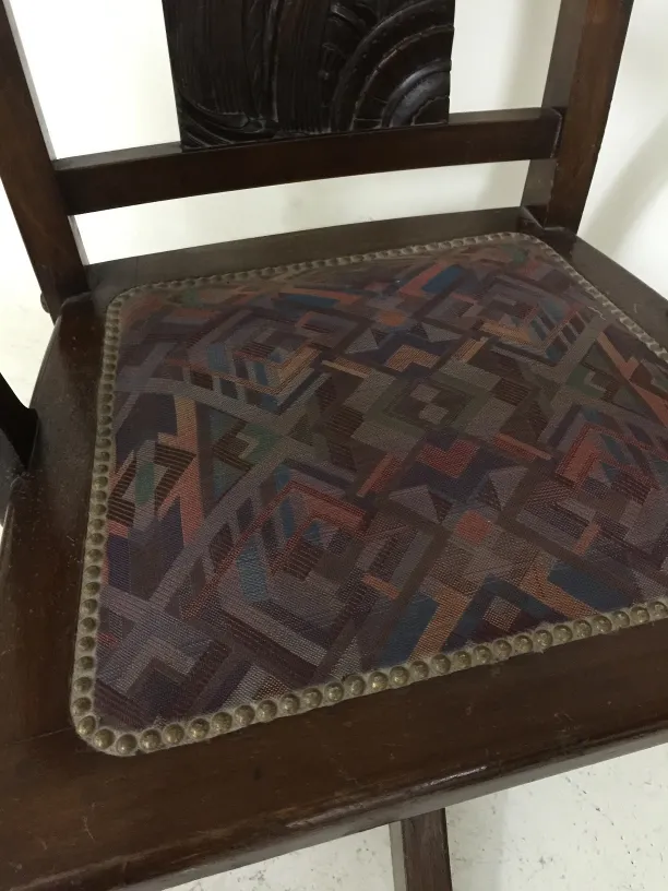 sillon de escritorio antiguo con un asiento decorado con patrones